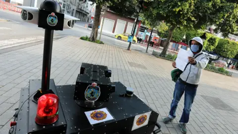 EPA A police robot questions someone in Tunis, Tunisia - 1 April 2020
