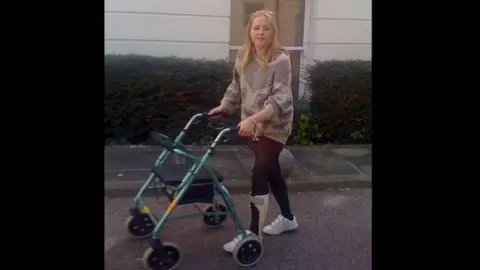 Becki Cobb Becki Cobb uses a walking frame during the early phase of her recovery