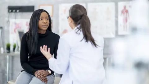 Getty Images A stock image of a doctor and patient