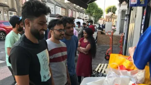 BBC Greenwich university MBA students queue for food