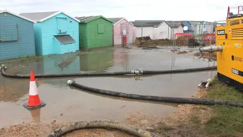 Kevin Boorman Flooded beach huts in Bulverhythe in August