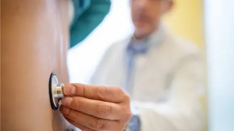 Stock image of a man being examined by a doctor