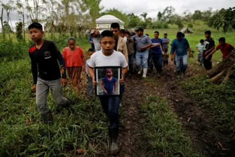 Reuters Friend and family carry a coffin with the remains of Jakelin Caal, a 7-year-old girl who handed herself in to U.S. border agents earlier this month and died after developing a high fever while in the custody of U.S. Customs and Border Protection, during her funeral at her home village of San Antonio Secortez, in Guatemala December 25, 2018.