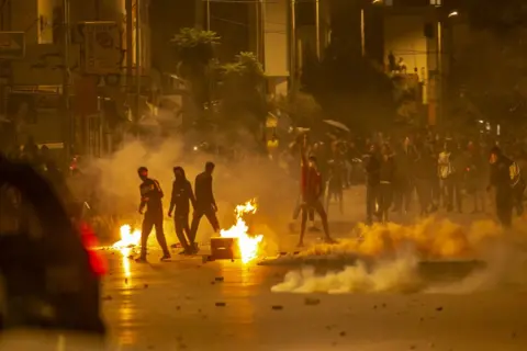 Getty Images Protesters burning tyres