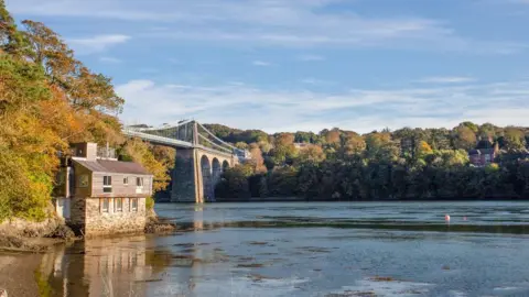 Menai Holidays A view of the Menai Strait and Menai Bridge beside Belgian Prom on Anglesey