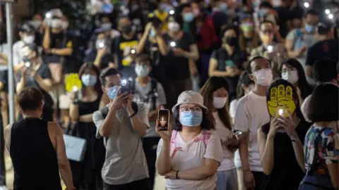 EPA People hold their phone lights aloft to mark Tiananmen Square anniversary, June 2021