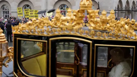 Reuters The King and Queen went past some of the protesters as they travelled in the Diamond Jubilee State Coach towards Westminster Abbey