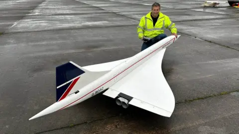Andy johnson Andy Johnson next to the 11ft long model of the Concorde