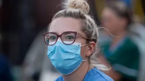 Getty Images Woman wearing a mask