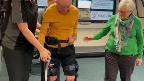 Harold walking in wearable robotic device