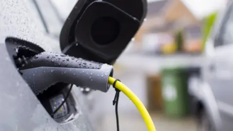 Getty Images An electric car being charged