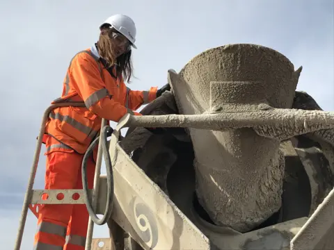 BBC Emily Burridge inspects a batch of concrete