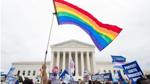 CQ-Roll Call Inc via Getty Images Protesters rally in front of the Supreme Court as it hears arguments on whether gay and transgender people are covered by a federal law barring employment discrimination on the basis of sex on Tuesday, Oct. 8, 2019