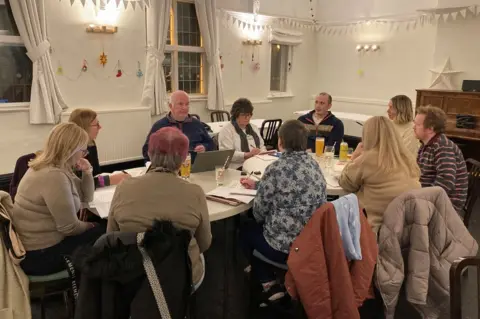 People holding a meeting around a table