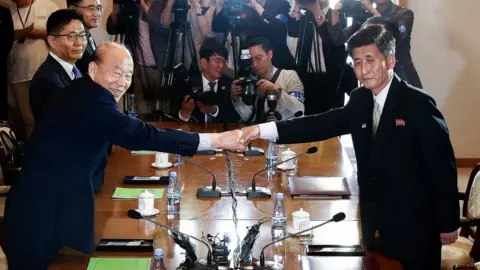 Getty Images South Korean Park Kyung-seo (L) head of the Korean Red Cross, shakes hands with Pak Yong-il (R) vice chairman of the Committee for the Peaceful Reunification
