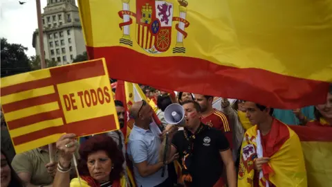 AFP Protesters wave Spanish and Catalan flags during a demonstration called by Catalan Civil Society under the motto "Catalonia yes, Spain too" in Barcelona on October 12, 2017.