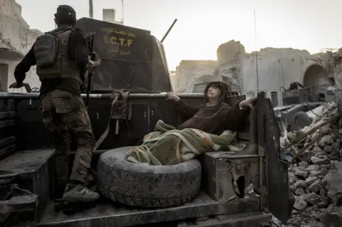 Rasmus Flindt Pedersen An elderly woman is driven through Mosul, Iraq, as the Golden Division help her flee the front line in extreme heat.