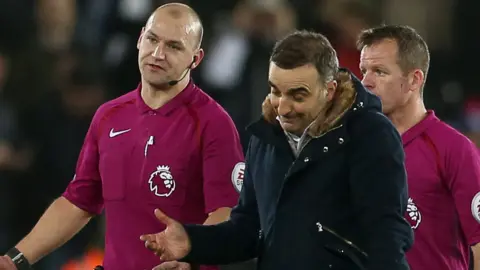 Swansea Manager Carlos Carvalhal talks to officials at full time