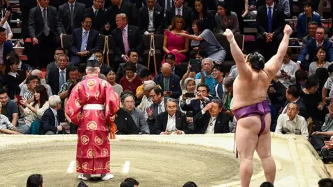 AFP President Donald Trump watches a sumo battle during the Summer Grand Sumo Tournament in Tokyo on May 26, 2019