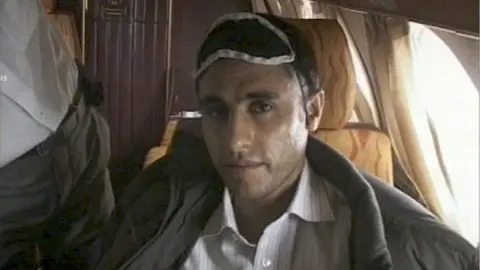 Reuters This frame grab released February 23, 2010 from Iranian state TV shows Sunni Muslim rebel leader Abdolmalek Rigi under armed guard following his arrest. Rigi is on board a small plane.