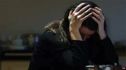 PA Woman with head in hands