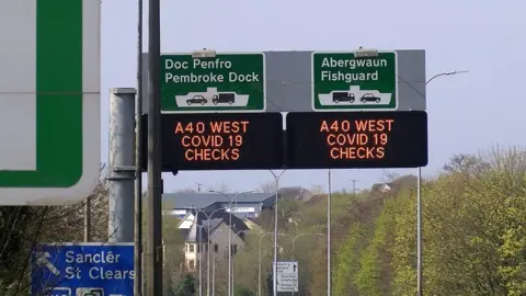 BBC Signs on the A40 alerting drivers to Covid-19 checks