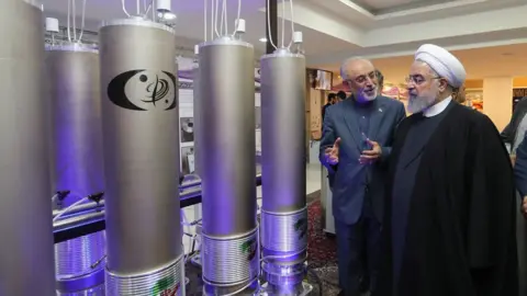 EPA Iranian President Hassan Rouhani (3rd Left) is shown nuclear technology in Tehran, Iran (9 April 2019)