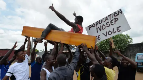 AFP Protestors carry coffins as they wave placards during a rally in front of the morgue of Yopougon University Hospital in Abidjan on March 7, 2018, as they stage a protest against IVOSEP - the dominant funeral service provider in Ivory Coast. Hundreds of small undertaker firms in Ivory Coast have gone on strike over what they described as abusive practices by the country's dominant funeral company.