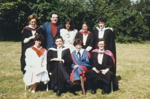 Getty Images Elisabeth and Robert Maxwell with their children Kevin, Philip, Ian, Anne, Christine, Isabel and Ghislaine Maxwell (top row, third from the left)