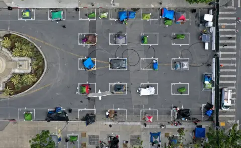 Getty Images An aerial view showing tents set up in individually marked spaces on the ground