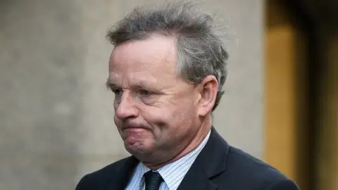 Leon Neal/Getty Images Andy Hill arrives at the Old Bailey