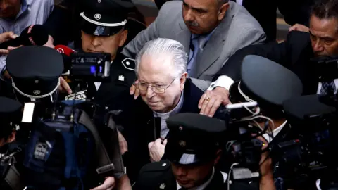 Reuters Chilean priest Fernando Karadima is surrounded by members of the media as he leaves the Supreme Court building in Santiago, Chile
