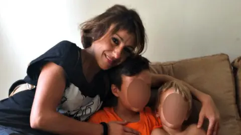 EPA Juana Rivas (L) and her children taken at an unknown location, issued 15 August 2017