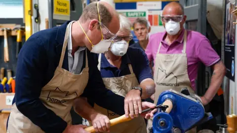 PA Media Prince William using a lathe