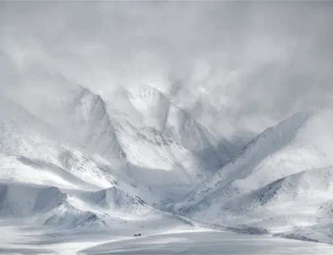 Ricardo Da Cunha A landscape view of snow-covered mountains