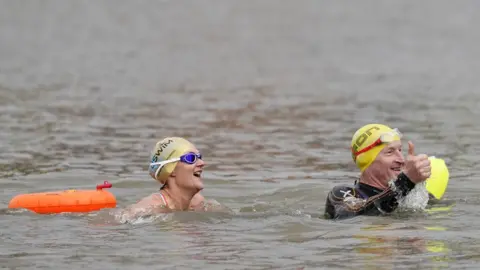 Andrew Matthews David and Karen Quartermain swimming in the Bristol Harbour