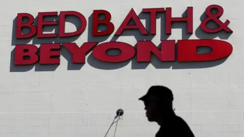 Customer walking in front of a Bed, Bath & Beyond store