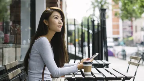 Getty Images A woman using a smartphone (stock image)