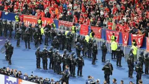 Getty Images Riot police at the Liverpool end of the Stade de France