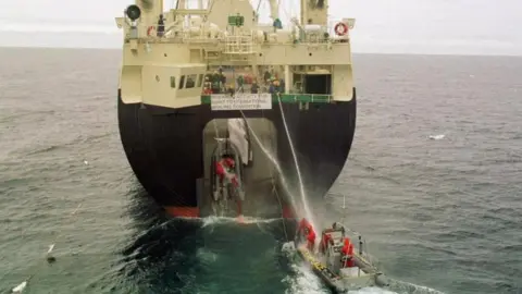 PA Japanese scientific whaling ship pulling up a whale