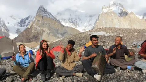 Hamid Hussein Ali Sadpara playing drums on a jerry can with a Dutch group during a K2 trek at a point called Concordia - July 2012