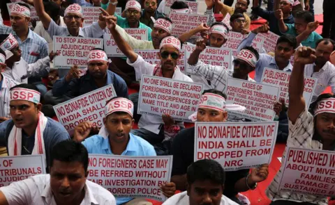 EPA Members of an Assam-based political party protest against the exclusion of people from the National Register of Citizens in Delhi on 4 August 2018.