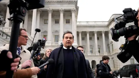 Getty Images George Santos and reporters