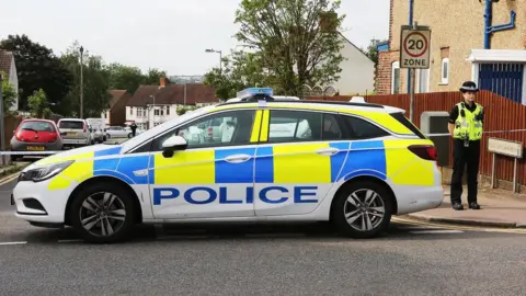 South Beds News Agency Police officer and car in Preston Gardens, Luton