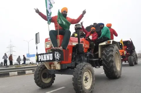 EPA Indian farmers participate in the tractor rally to protest against the government's new agricultural laws at the Kundli Manesar Palwal (KMP) Expressway at Kundli, Haryana state, India, 07 January 2021.