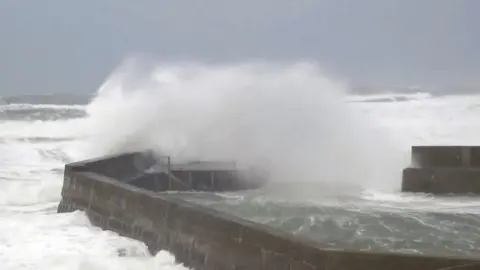 Police have warned people not to travel in areas covered by a Met Office red wind warning.