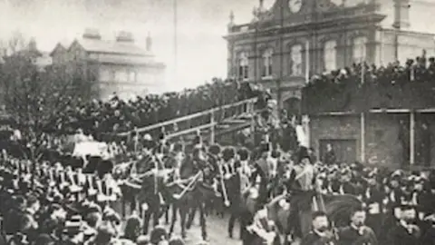 Frank Beken A crowd watches the procession