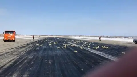 YAKUTIAMEDIA.RU Precious metal bars scattered across the runway at Yakutsk airport on 15 March