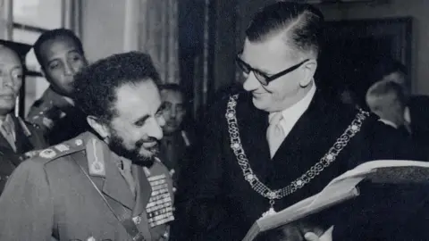 Bath & North East Somerset Council Black and white photo of Emperor Haile Selassie pictured left with the Mayor of Bath, Cllr. Gallop pictured right