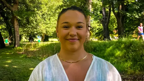 head and shoulders shot of woman in park